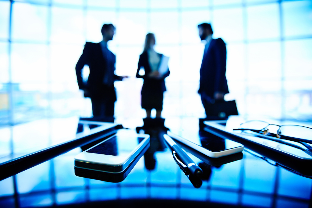 mobile-phones-with-silhouettes-executives-background.jpg